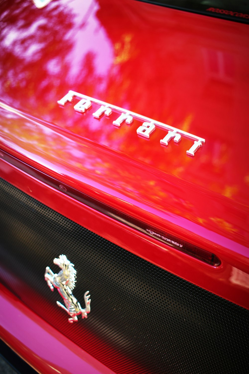 a close up of the hood of a red car