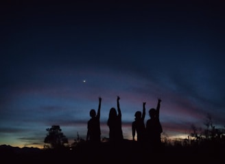 Close-up of the quartet harmonizing during an outdoor event at sunset