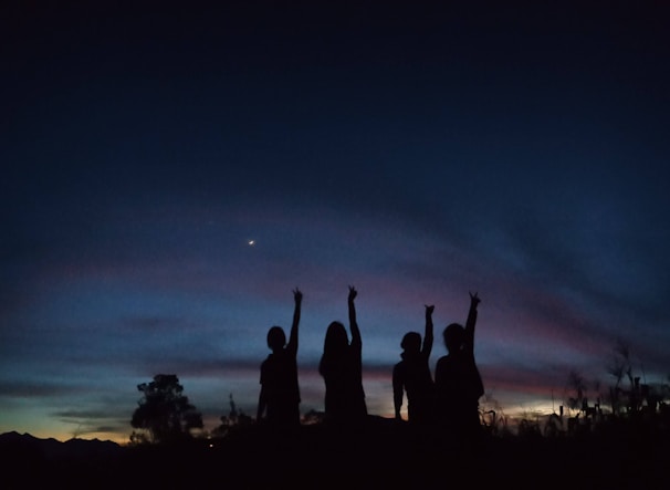 Close-up of the quartet harmonizing during an outdoor event at sunset