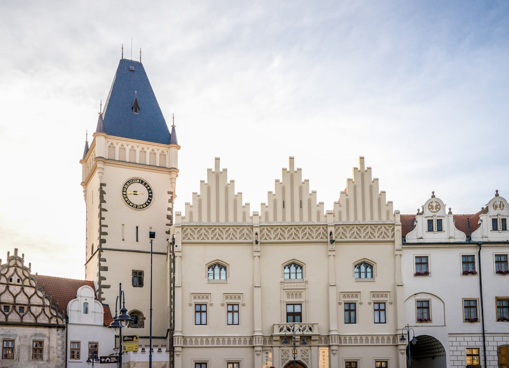 un grand bâtiment blanc avec une tour de l’horloge