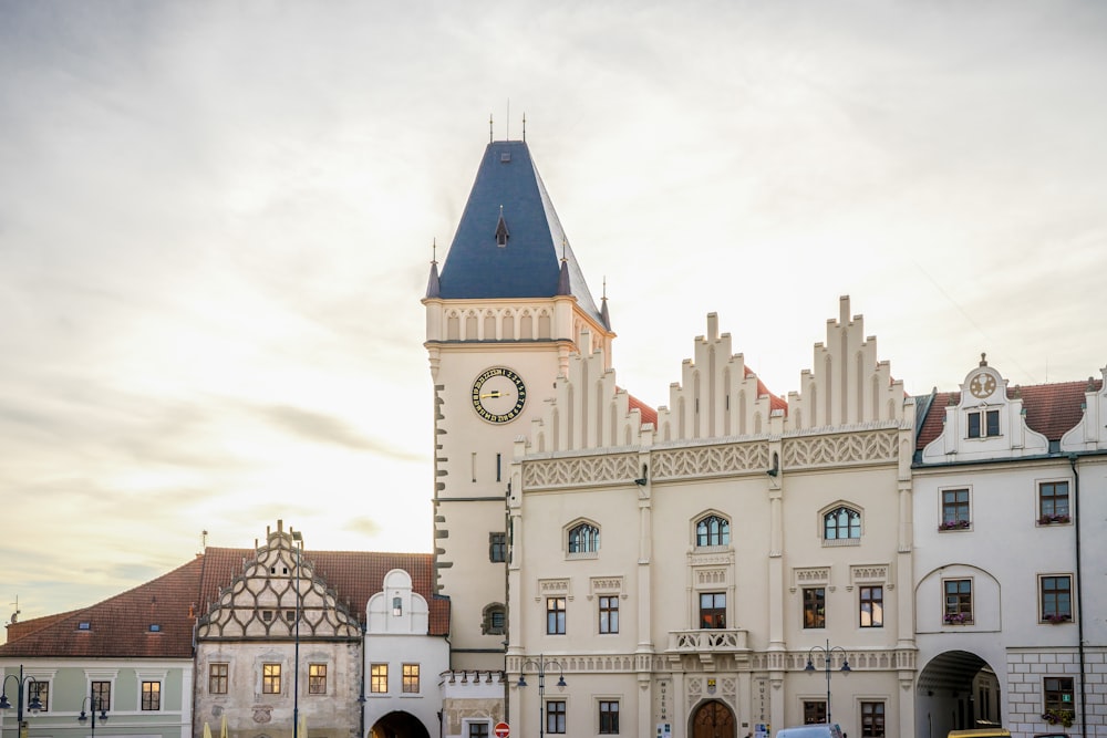 a large white building with a clock tower