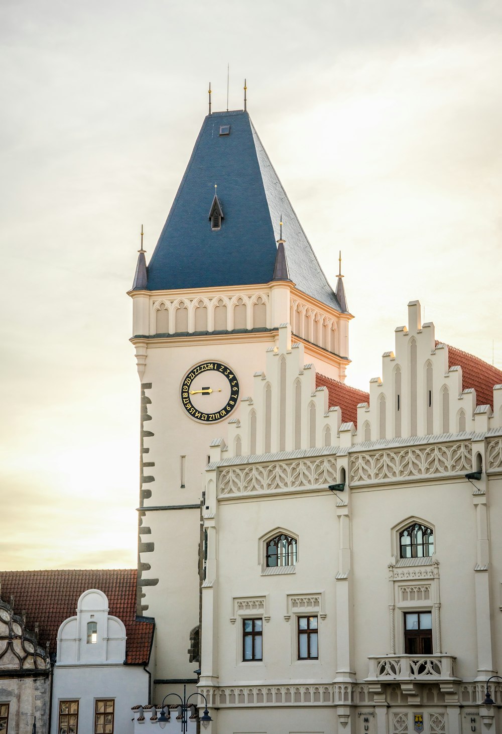 a large white building with a clock on it's side