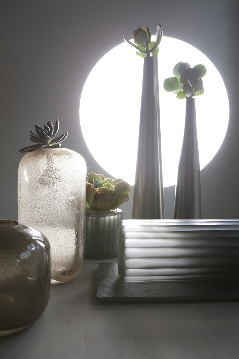 a group of vases sitting on top of a table