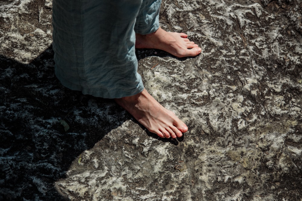 a person standing on top of a large rock