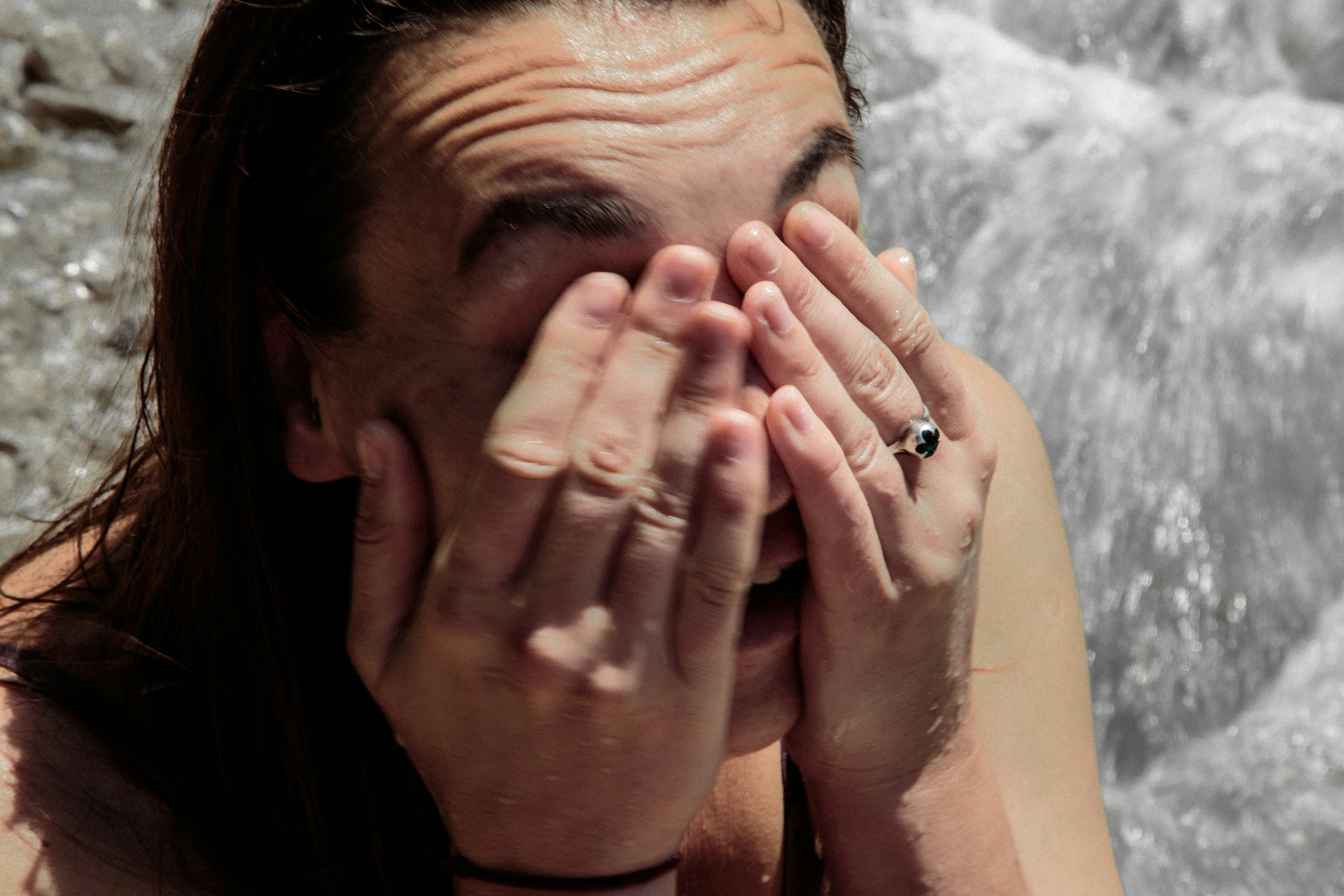 a woman covers her face with her hands