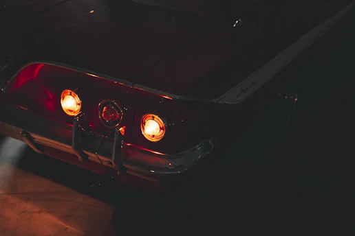 a close up of a car with its lights on