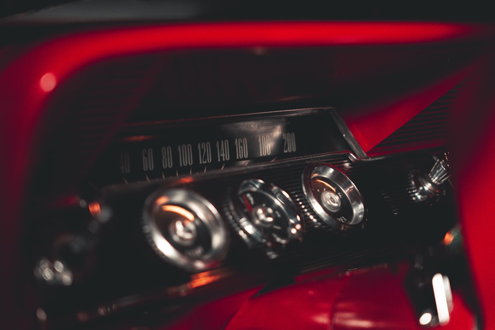 a close up of a radio on a red car