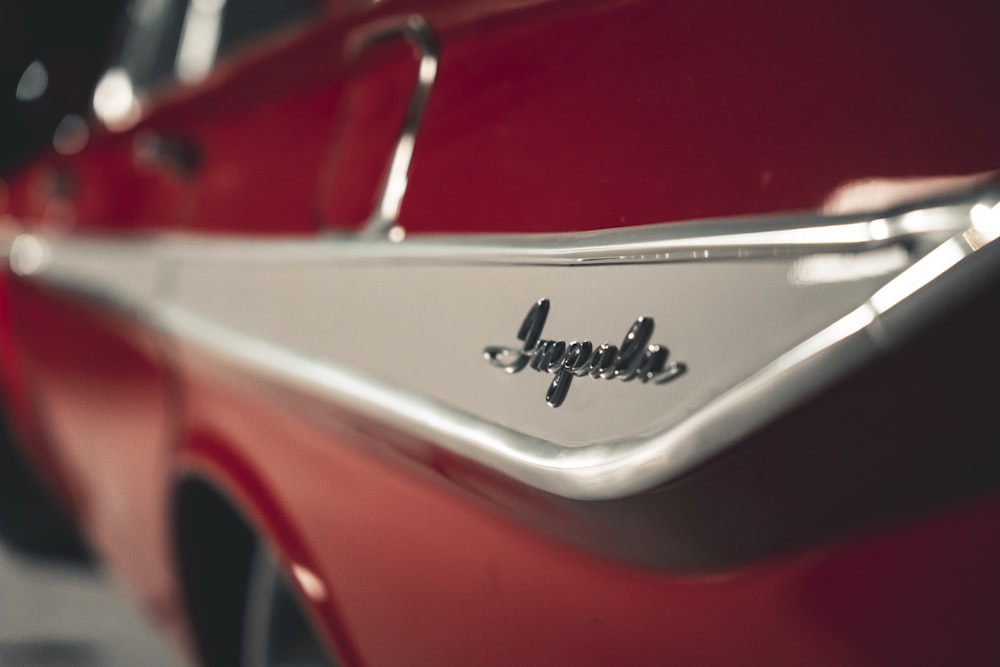 a close up of the emblem on a red car