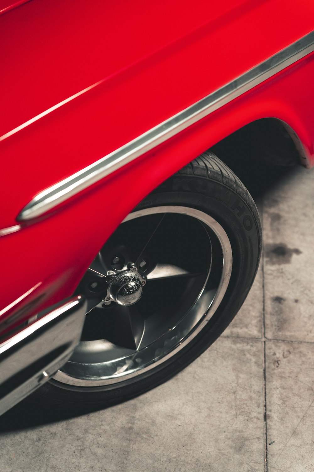 a close up of a red car tire