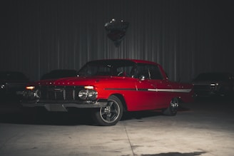 a red car is parked in a garage