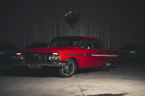 a red car is parked in a garage