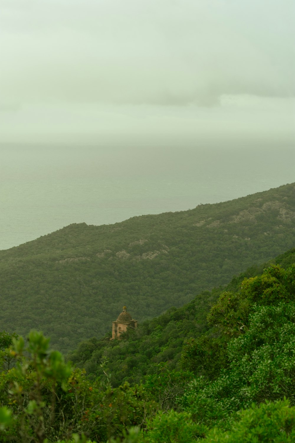 a view of a mountain with a house on top of it