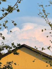 A freshly replaced roof on a charming Lewisburg home under a clear blue sky.