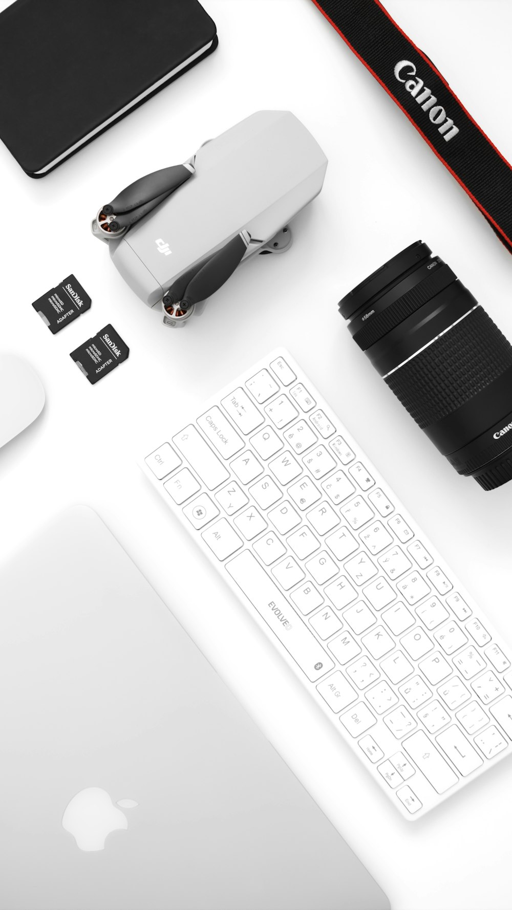 a camera, keyboard, mouse, and other electronics on a desk