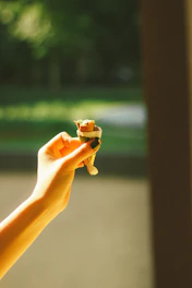 A warm close-up of hands gently holding a small snack, symbolizing the choice to skip it.