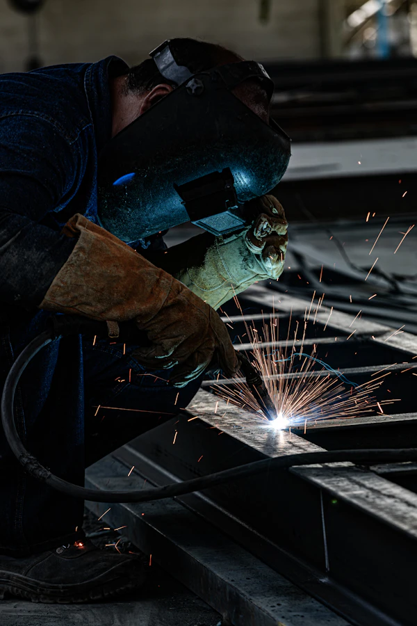 Welder performing precision work in industrial shop