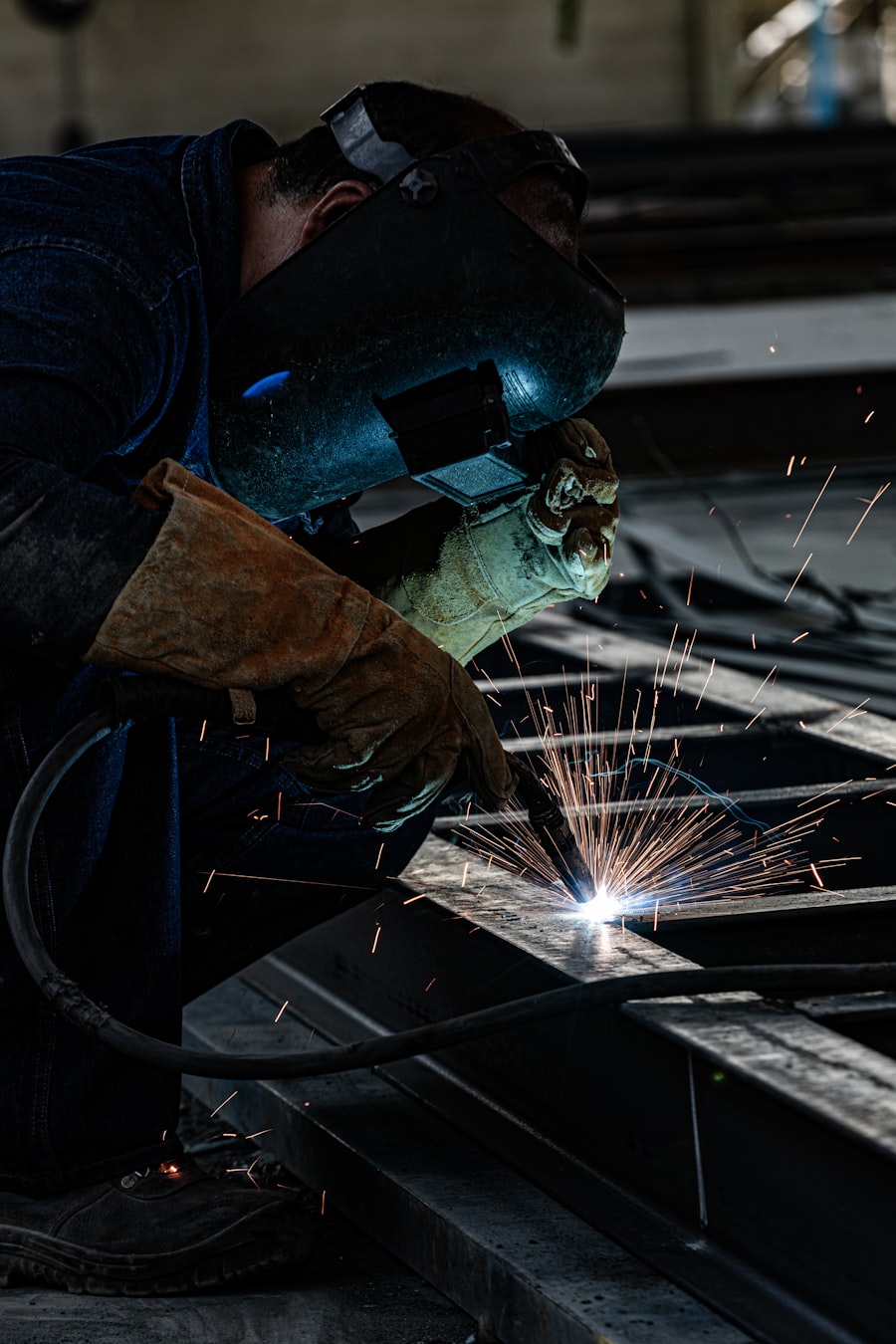 Fabricator grinding a structural steel beam