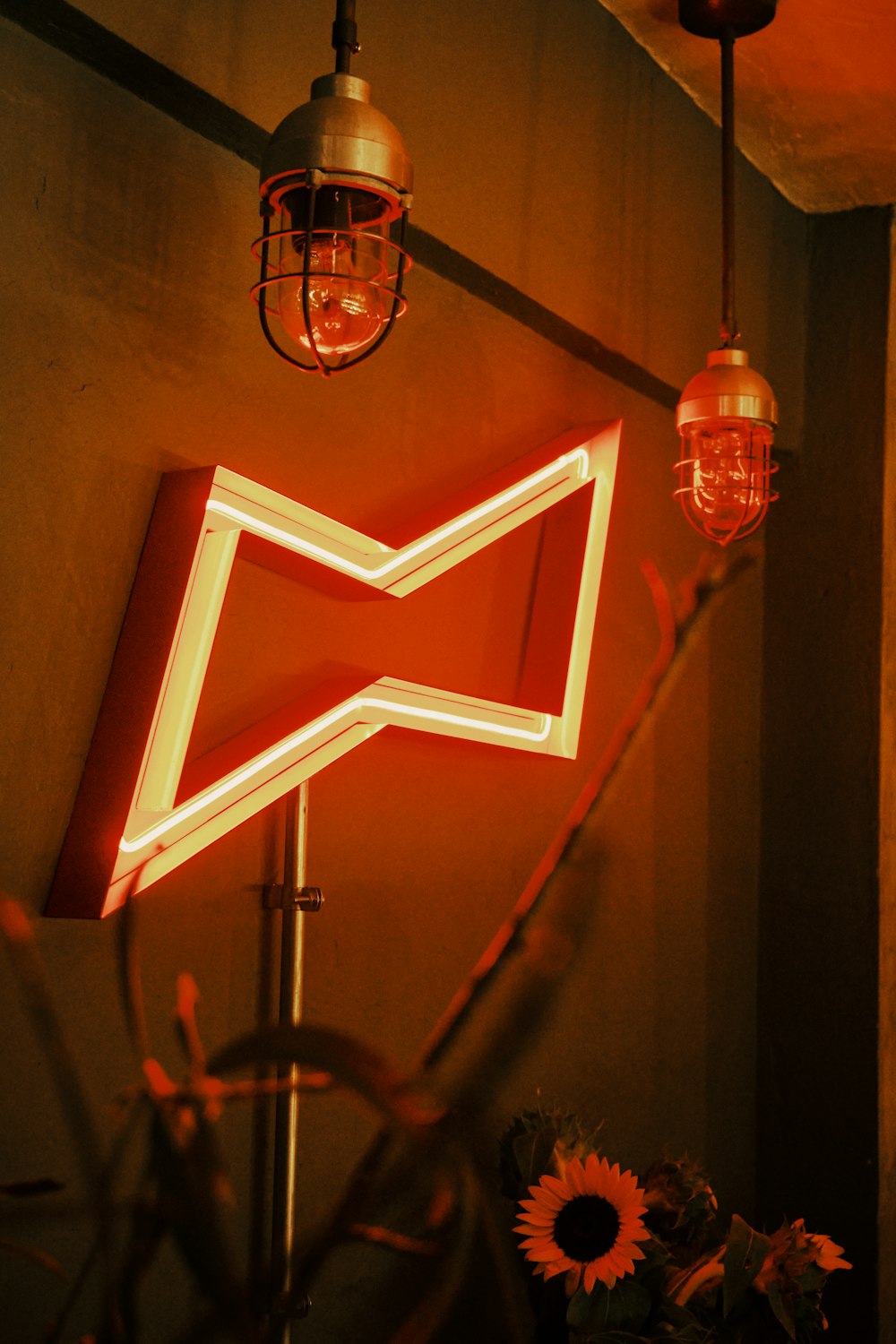 a red neon sign sitting on the side of a wall