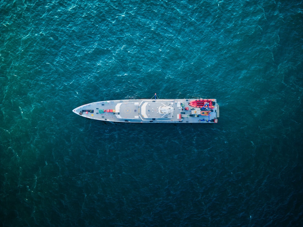 an aerial view of a boat in the ocean