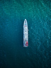 A navy blue-themed digital strategy map overlaying a ship's navigation charts.