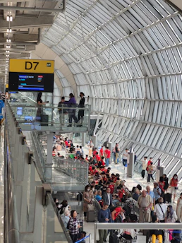 A traveler happily activating an eSIM on their smartphone at the airport arrival gate