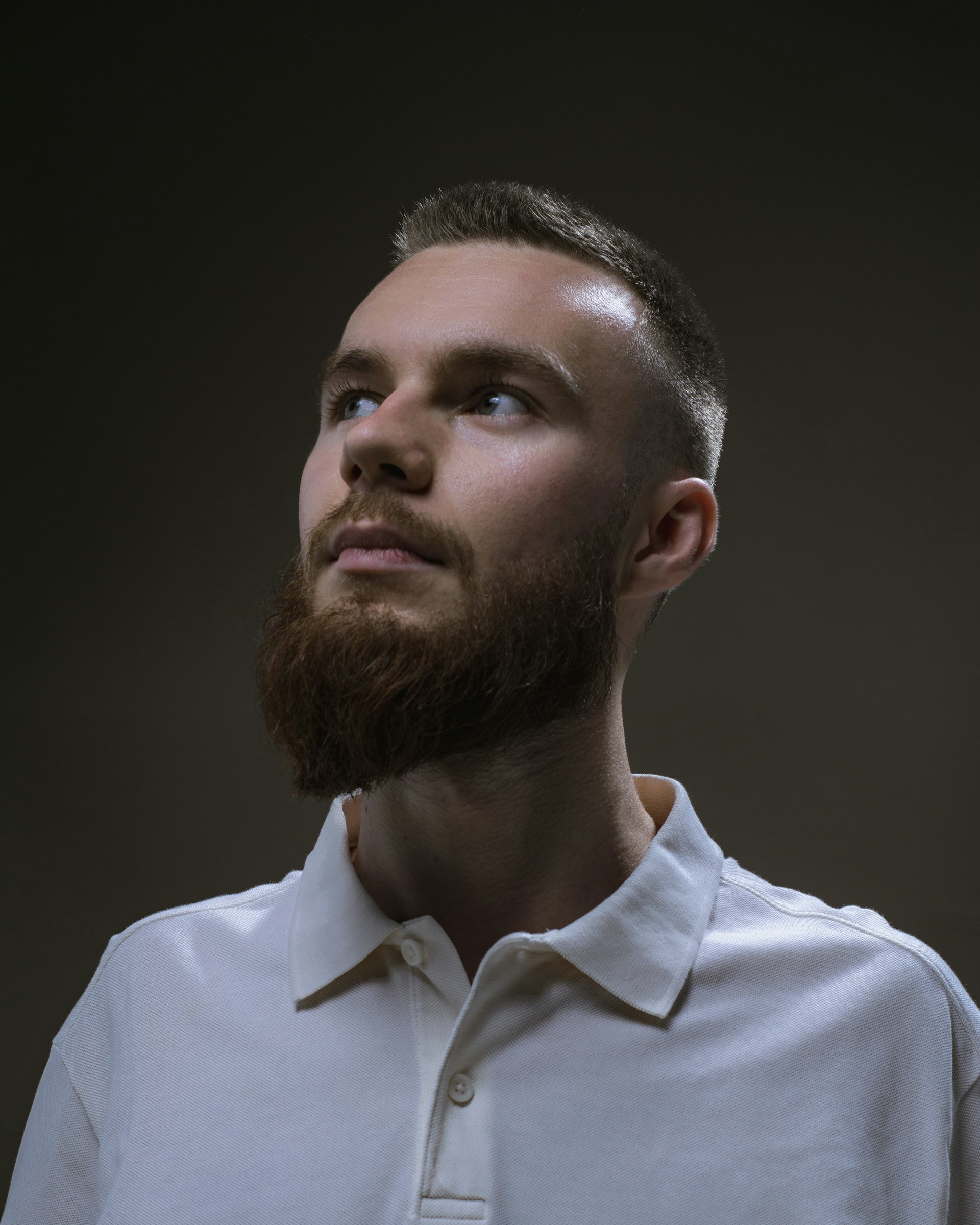 a man with a beard and a white shirt