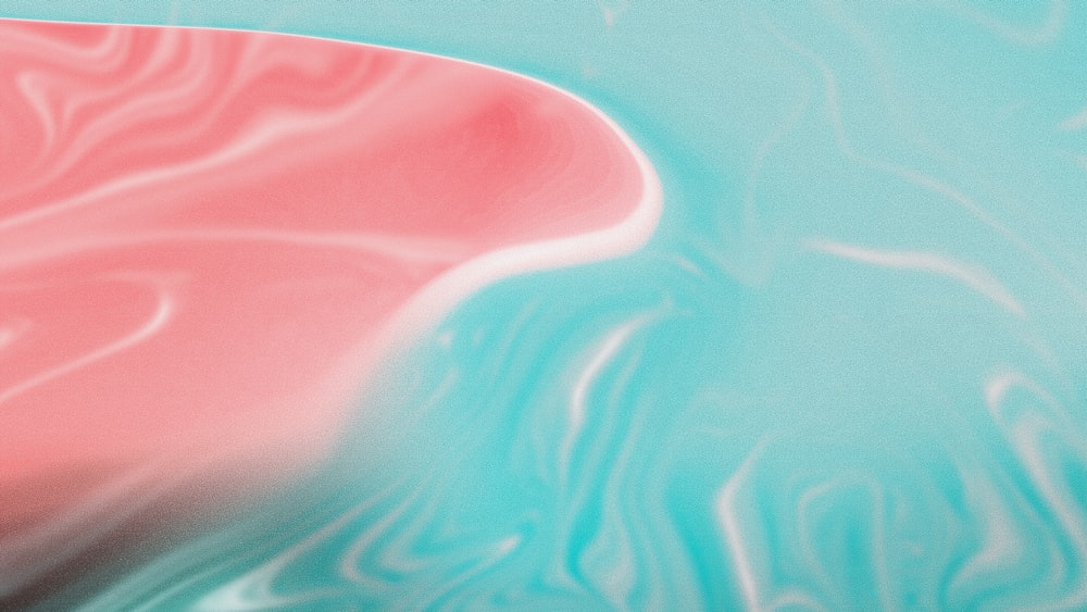 a pink and blue object floating on top of a body of water