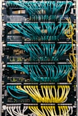 a rack of servers with wires and wires attached to them