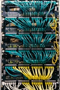 a rack of servers with wires and wires attached to them