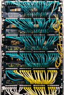 a rack of servers with wires and wires attached to them