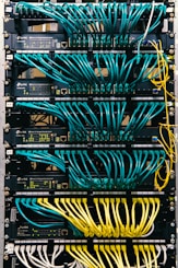 a rack of servers with wires and wires attached to them