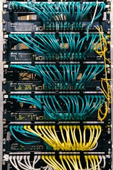 a rack of servers with wires and wires attached to them
