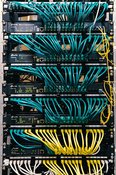 a rack of servers with wires and wires attached to them