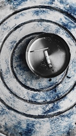 Close-up of a sleek aerospace-grade aluminum portable ashtray with magnetic base inside a car cup holder.