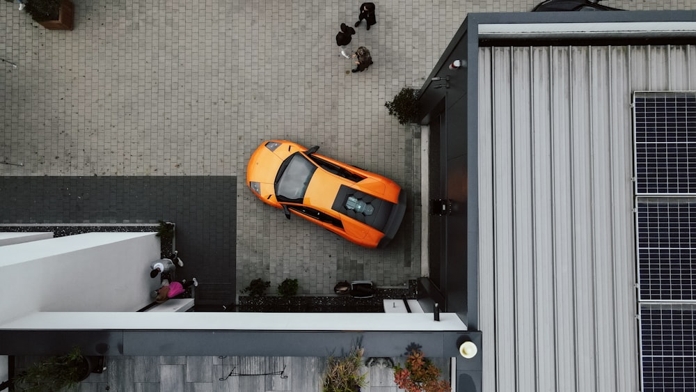 an overhead view of an orange sports car