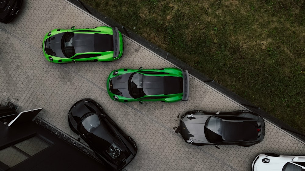 three green sports cars parked next to each other