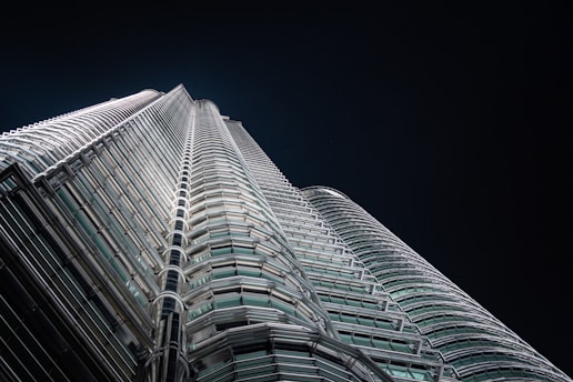 A sleek, dark-toned image of a luxury modern building with gold highlights