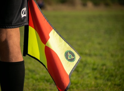 a soccer player holding a flag on a field