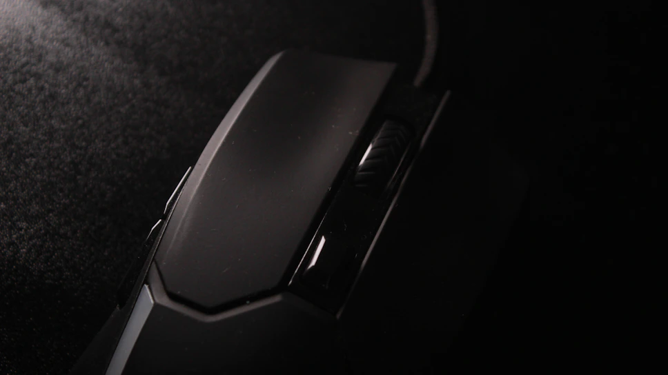 Close-up of the Cardix foldable mouse partially unfolded on a sleek, reflective surface.