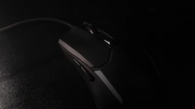 A high-performance gaming mouse with ergonomic design on a dark desk.