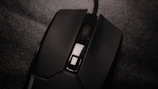 Close-up of a high-tech wireless mouse resting on a textured mousepad.