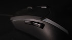 Dynamic shot of a gamer’s hand gripping a high-precision gaming mouse on a textured mousepad.