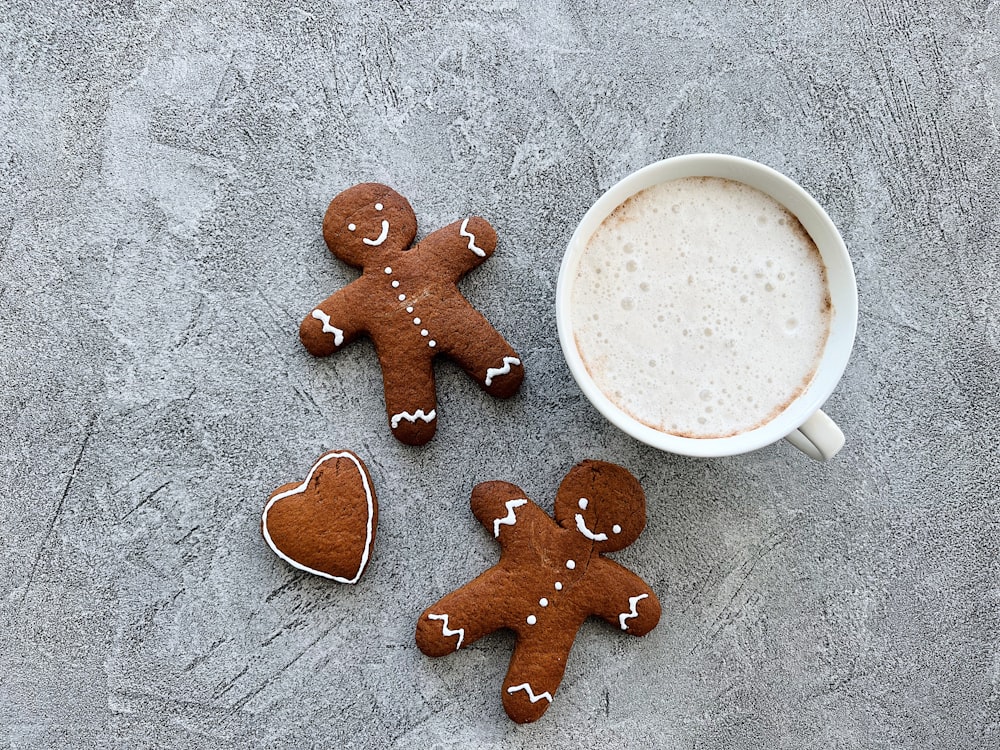 a cup of coffee and three ginger cookies