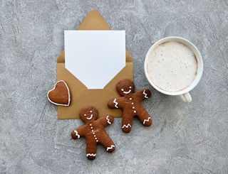 a cup of coffee and some cookies on a table