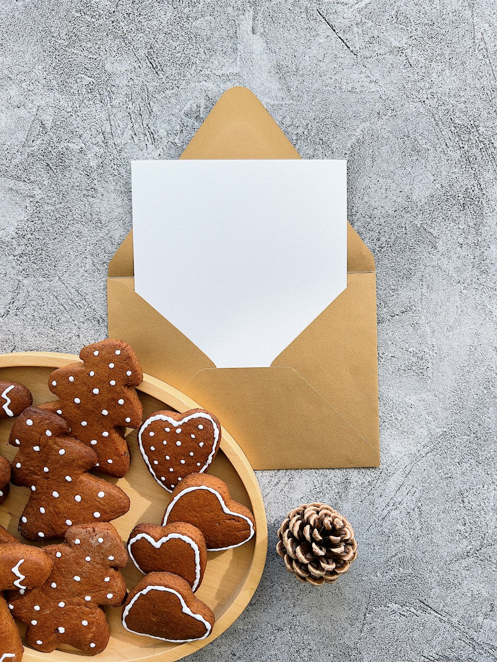 a plate of heart shaped cookies next to an envelope
