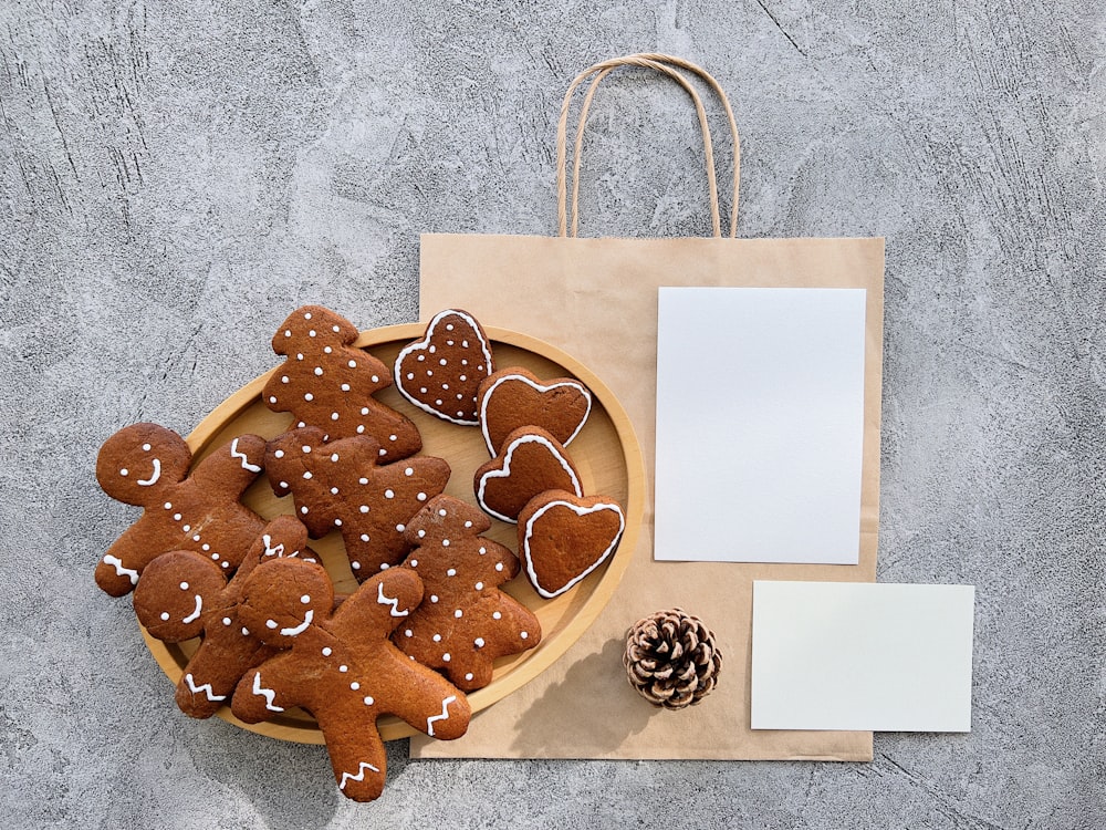 a plate of ginger cookies and a notepad on a table