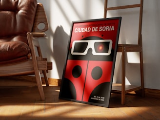 a red ladybug with glasses is sitting in front of a chair