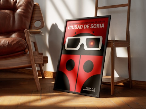a red ladybug with glasses is sitting in front of a chair