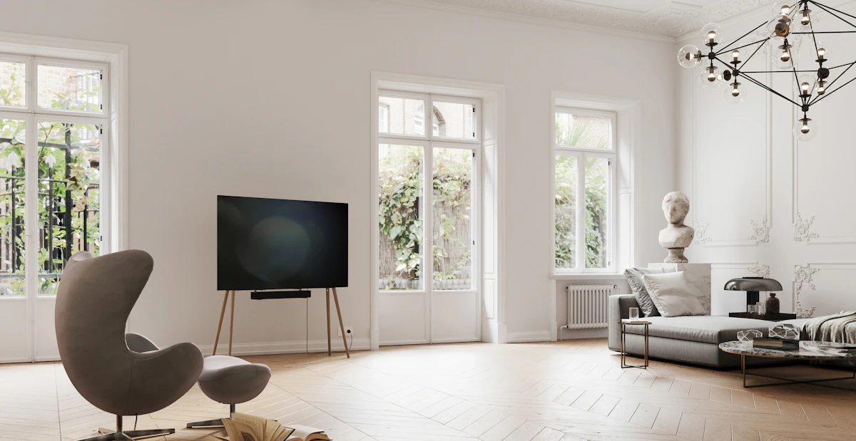 A modern living room with a large flat-screen television on a wooden media stand