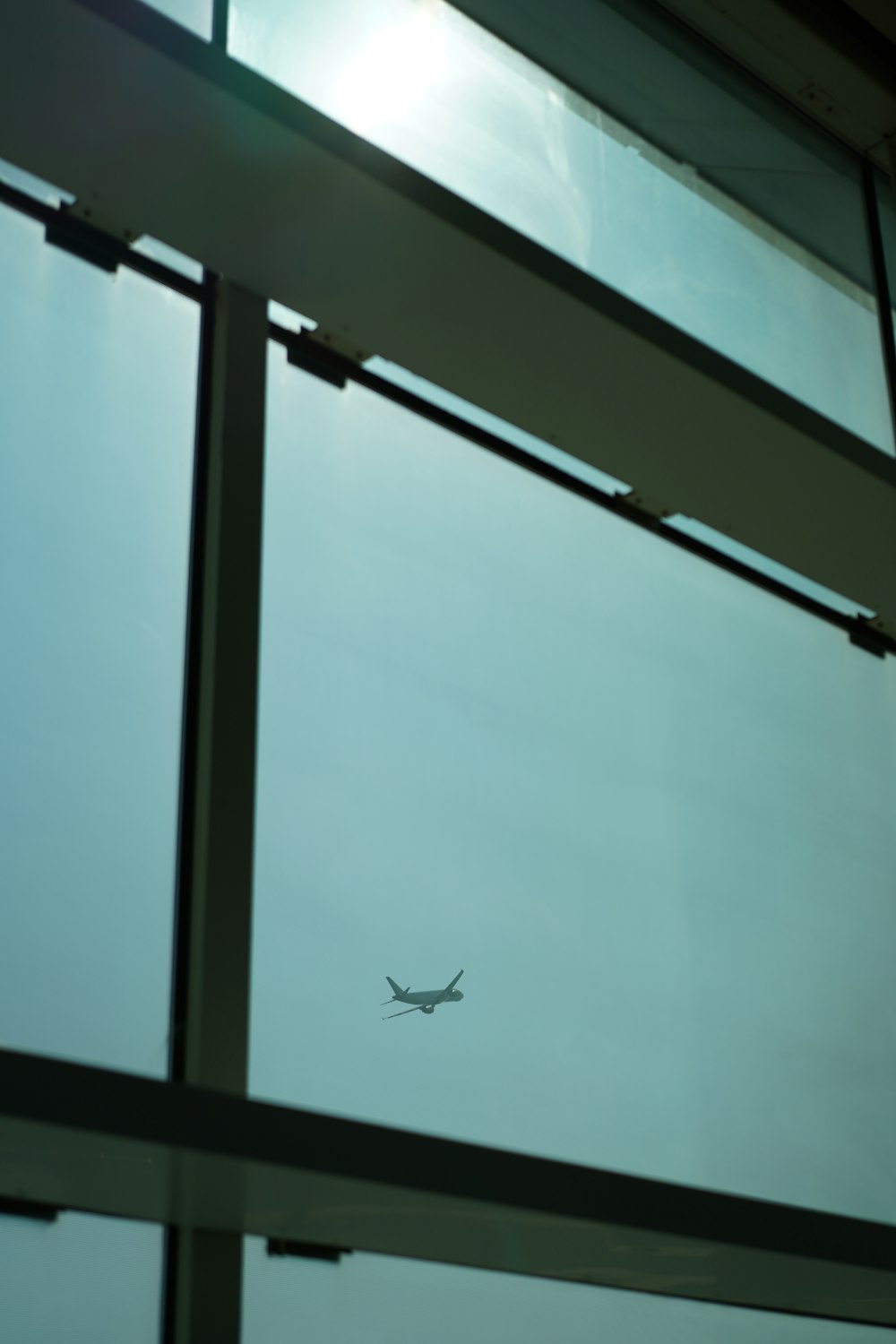 an airplane flying in the sky through a window